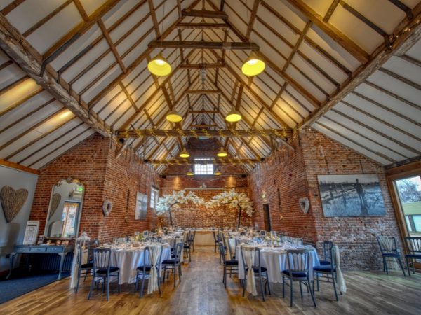 wedding barn with brick walls and barn roof in warm lighting