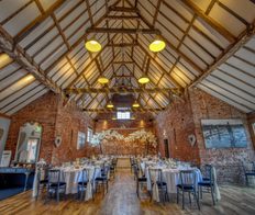 wedding barn with brick walls and barn roof in warm lighting