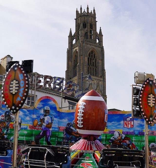 Boston May Fair rides with Boston Stump in the background with bright blue skies